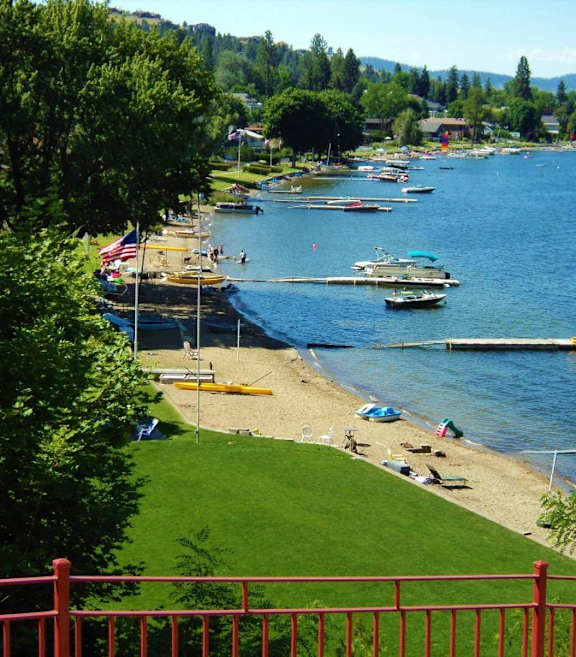 A beach with boats and a flag.