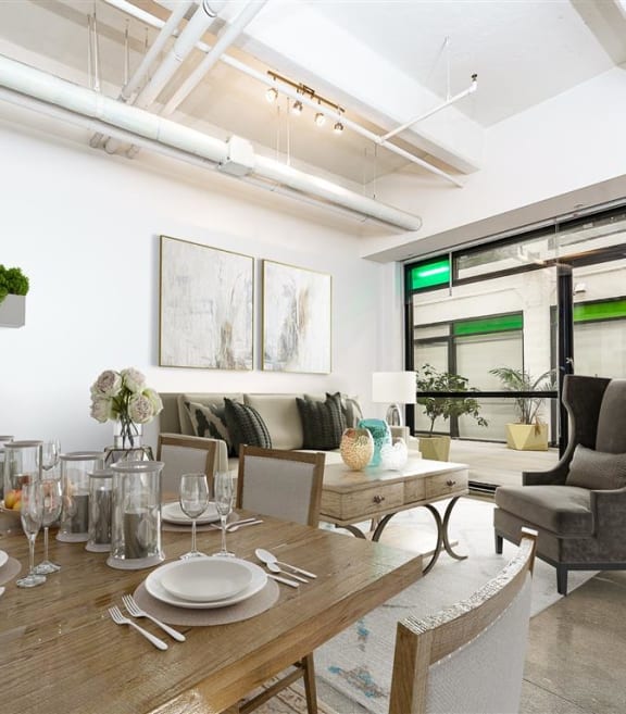a dining area with a wooden table and chairs
