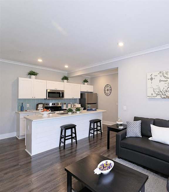 a living room with a couch and a kitchen