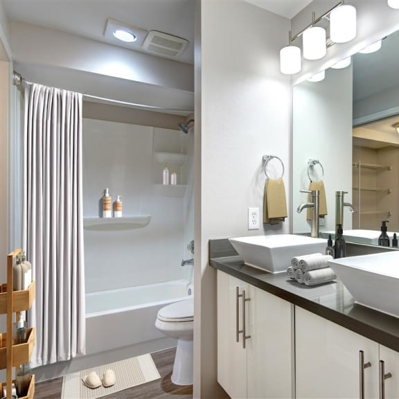 a bathroom with two sinks and a toilet