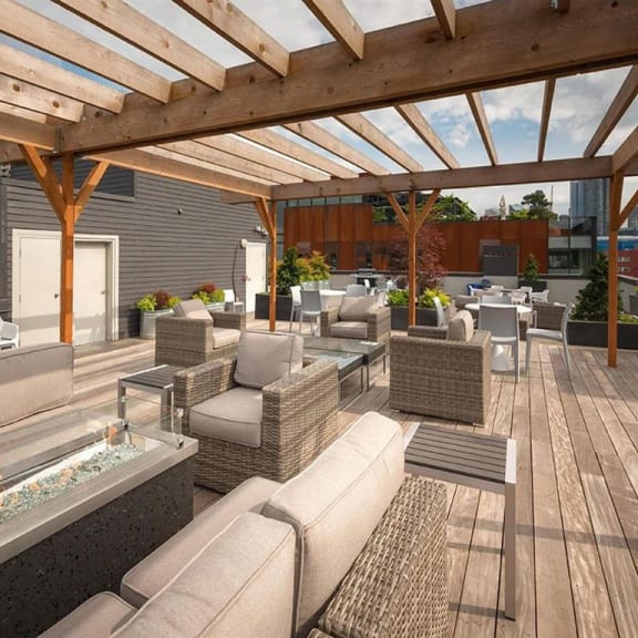 a roof deck with couches and tables