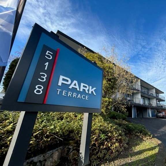 A sign for Park Terrace stands in front of a building.