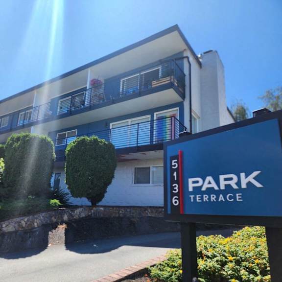 A building with a sign that says "PARK TERRACE" in front of it.