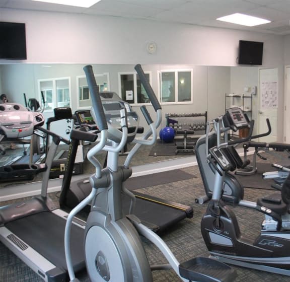 a gym with several pieces of exercise equipment
