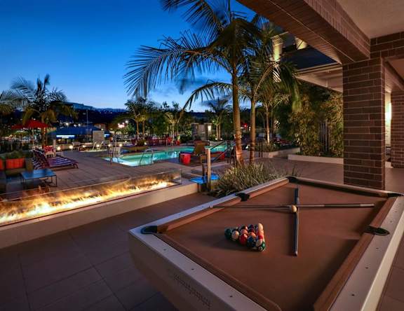 A large building with a pool in front of it. at West Park Apartments, California, 92108