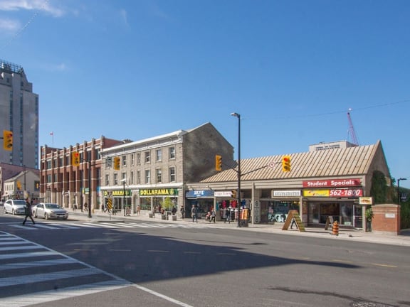 A street view of a city with a crosswalk and traffic lights.