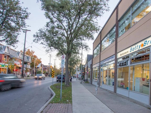 A street view with a tree, a car and a building with a sign that says "Beltry".
