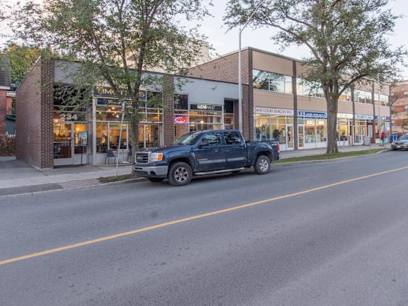 A dark blue pickup truck is parked on the side of a street.