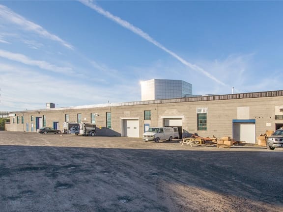 A large industrial building with a clear blue sky above.