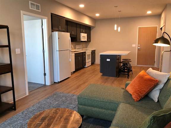 Open-concept 1-3 bedroom interior at Morrow Apartments in St. Paul, MN with a kitchen island and modern finishes.