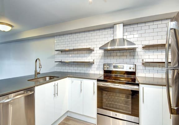 a kitchen with a stove top oven next to a sink