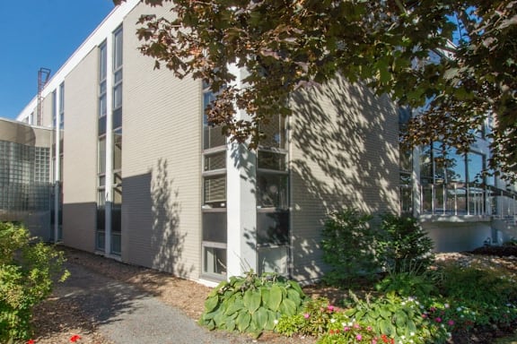 A modern building with a garden in front.