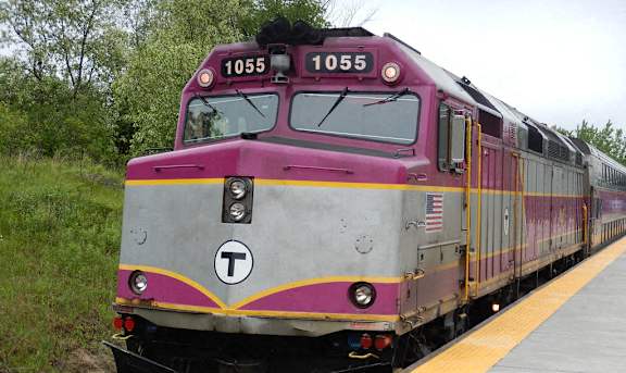 A train with the number 1055 on the front is on a track.