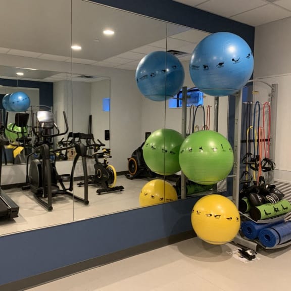 a workout room with weights and balls and other exercise equipment