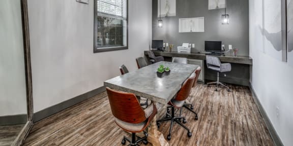 a conference room with a table and chairs and a large window  at Valor at Harlingen, Harlingen, Texas