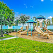 A playground with a blue slide and wooden structure.