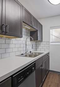 a kitchen with wooden cabinets and stainless steel appliances