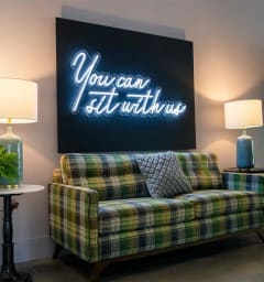 a living room with a couch and a painting on the wall at Flats at West Broad Village in Glen Allen, VA