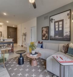 a living room with a couch and a table at Flats at West Broad Village in Glen Allen, VA 23060