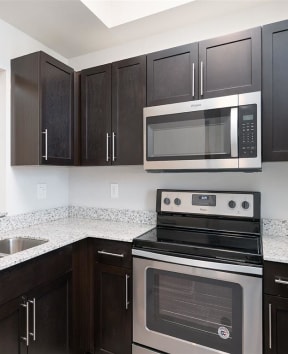 kitchen with a sink stove and microwave at Portofino Cove in Fort Myers