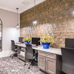 a conference room with a desk and chairs and a mirror