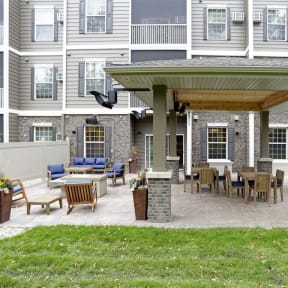 a covered patio with a table and chairs