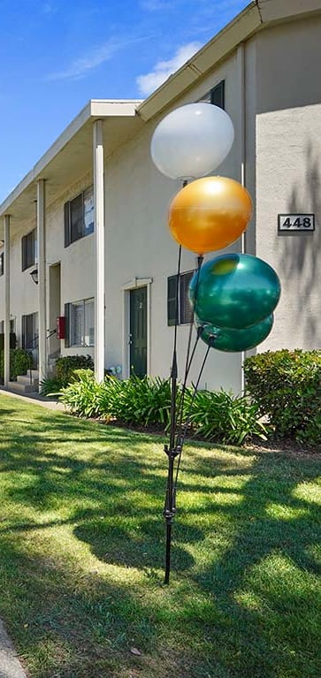 Sunlit courtyard with walkway at Colonial Garden Apartments, San Mateo, 94401