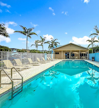 A swimming pool with a building in the background.