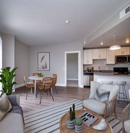 a living room and kitchen with a table and chairs