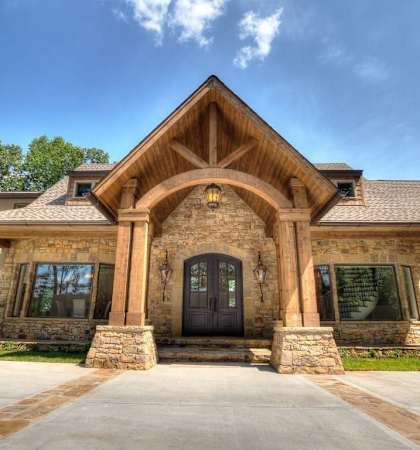 the front of a brick house with a black door