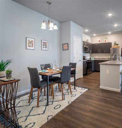 a dining room and kitchen with a table and chairs