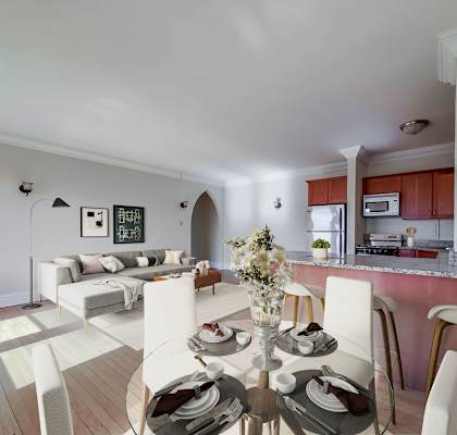 A modern dining room with a round table set for four.