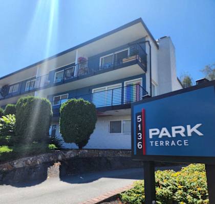A building with a sign that says "PARK TERRACE" in front of it.
