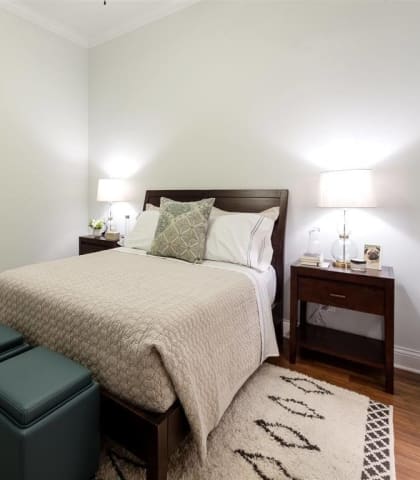 Bedroom with cozy bed and lights  at Wells Place Apartments, Chicago, Illinois