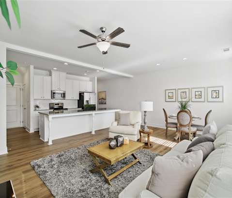 a living room with a couch and a ceiling fan