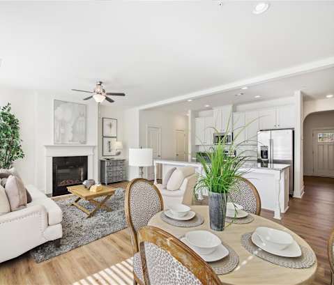a living room with a table and chairs and a fireplace
