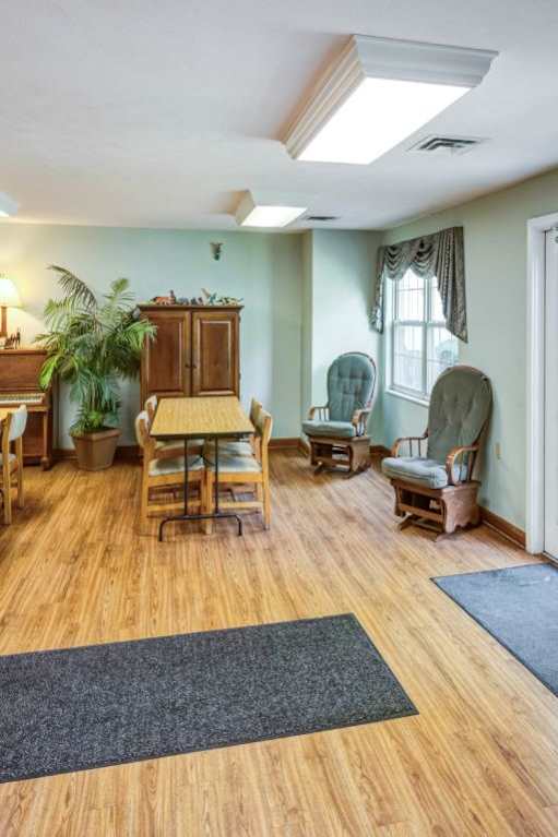a rendering of a dining room with tables and chairs and a kitchen