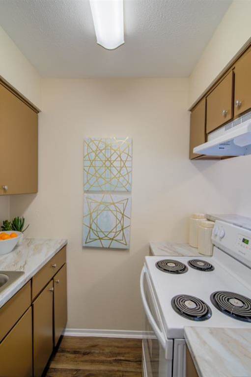 an office with blue chairs and a wooden desk at 46Eleven Apartments, Dallas, TX, 75228