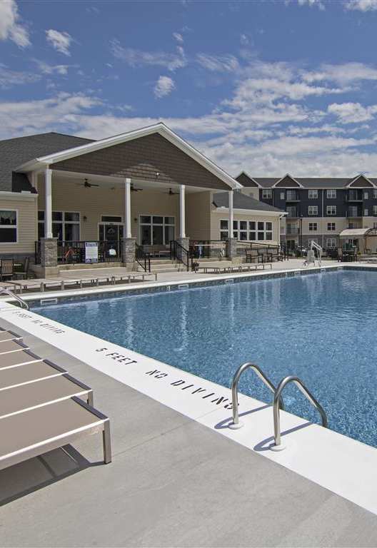 a swimming pool with apartments in the background