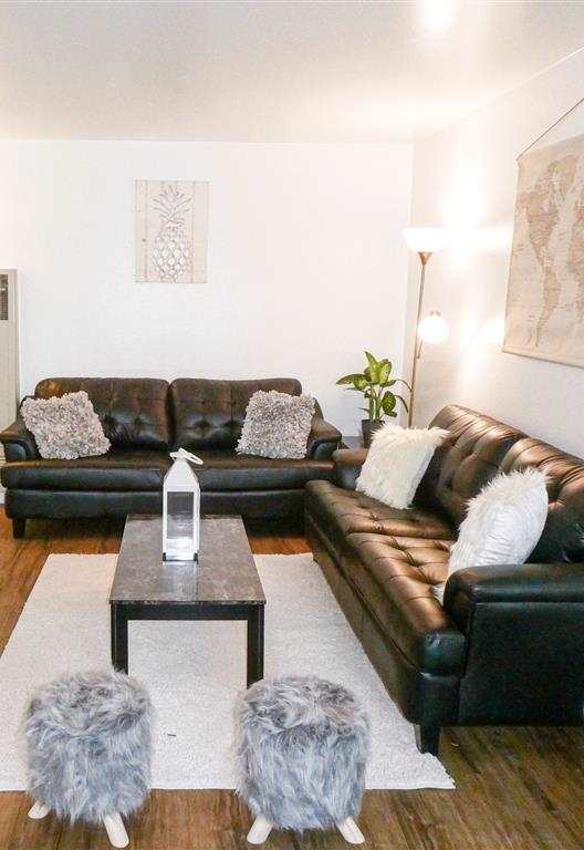 a living room with leather couches and a table