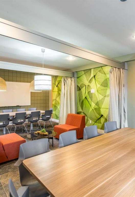 a conference room with a large wooden table and chairs