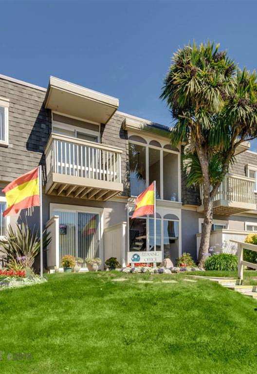 red and yellow flags in front of leasing center, Fairmont Apartments, Pacifica