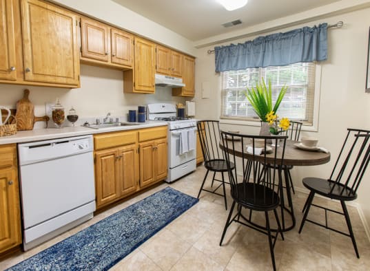 a kitchen with white appliances and wooden cabinets
