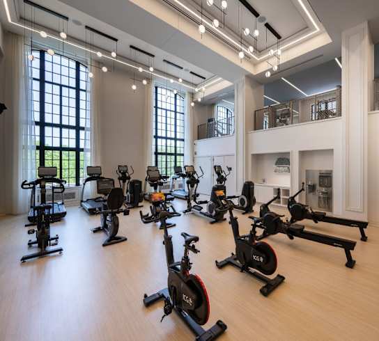 a gym with weights and exercise equipment in a large room