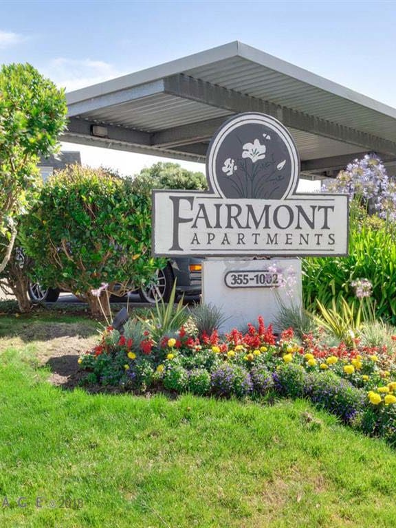 Verdant shrubbery surrounding Fairmont Apartments sign, California