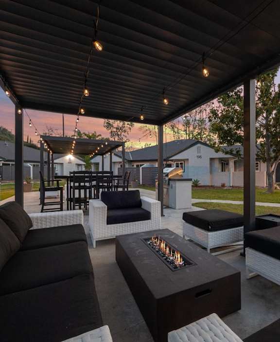 A modern kitchen with a dining area and a view of the balcony.
