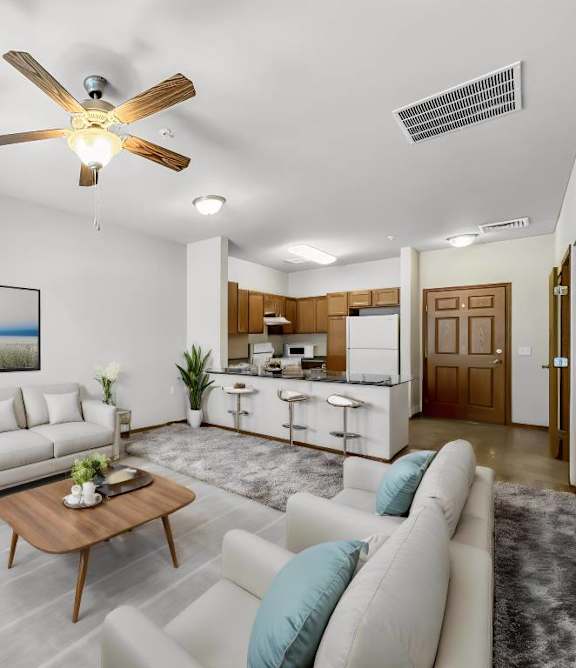 A living room with a white couch, a coffee table, and a ceiling fan.at Cornerstone Commons, Johnston, 50131