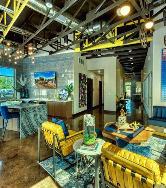 A room with a yellow chair and a blue couch. at Craft at Gilbert and Baseline Apartments, Arizona, 85204