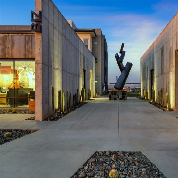 a sculpture in the middle of two buildings