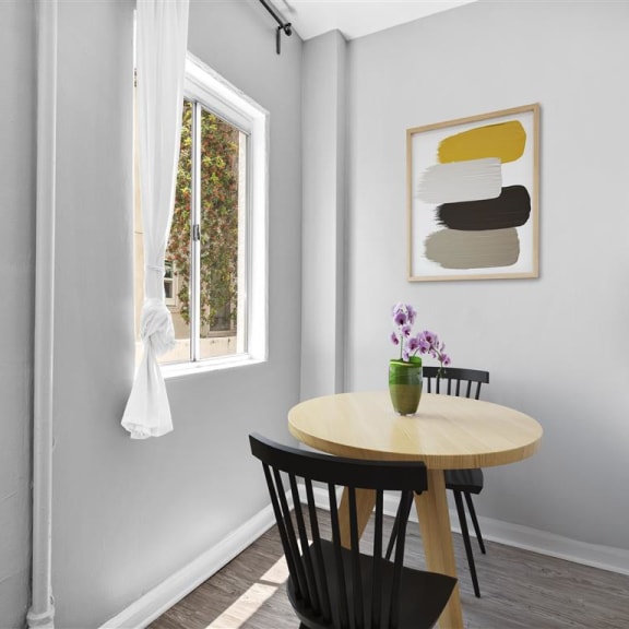Dining room with a table and chairs and a window at North Kingsley, Los Angeles, CA